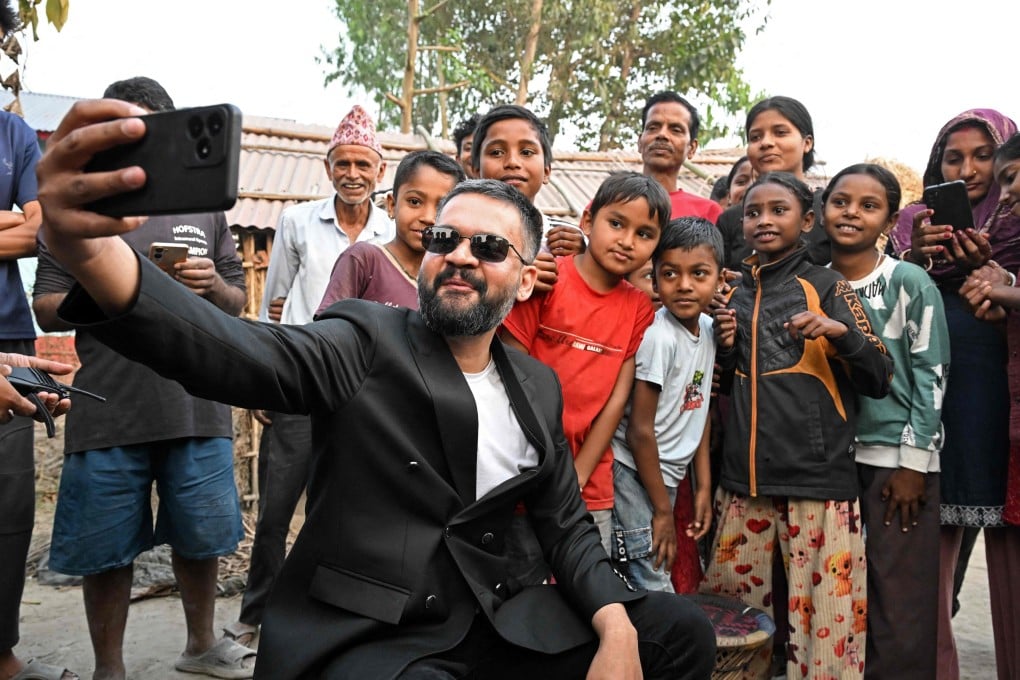 Balendra Shah of the Rastriya Swatantra Party takes a selfie with children and supporters during a door-to-door election campaign on February 16. Photo: AFP