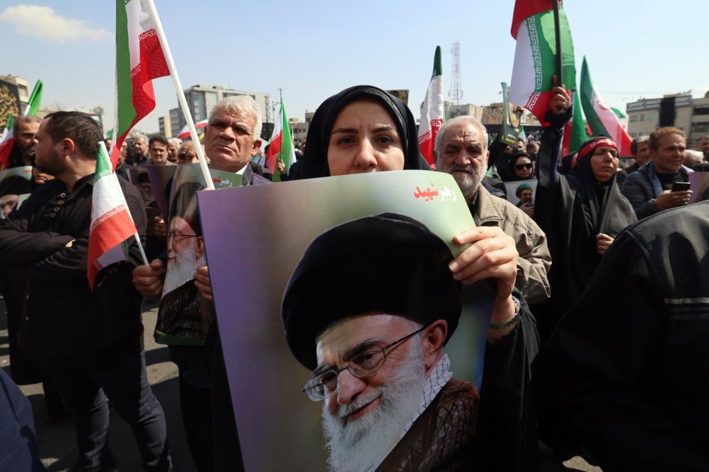 Mourners hold posters of Ayatollah Ali Khamenei, Iran’s late supreme leader, as they take part in a funeral procession for other war dead, in Tehran on Wednesday. Photo: EPA