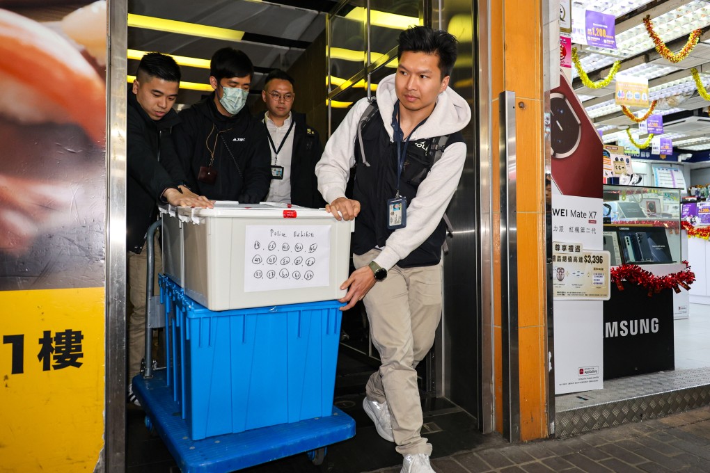 Police take away boxes from a law firm in Mong Kok during an operation last month. Photo: Handout