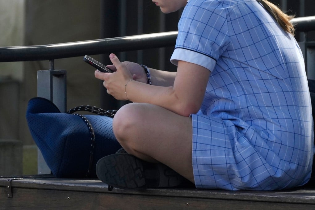 A girl in Sydney uses her phone. Australia restricted young people’s access to social media services late last year. Photo: AP