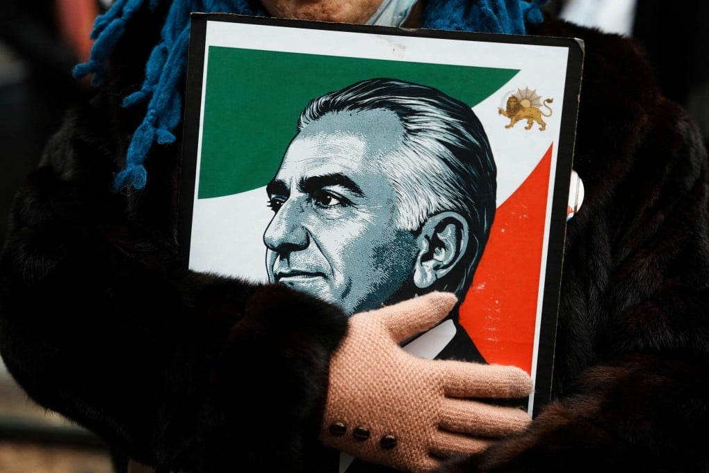 A protestor in New York City holds an image of Reza Pahlavi, the exiled son of Iran’s last shah, during a demonstration against the Iranian government. Photo: Reuters