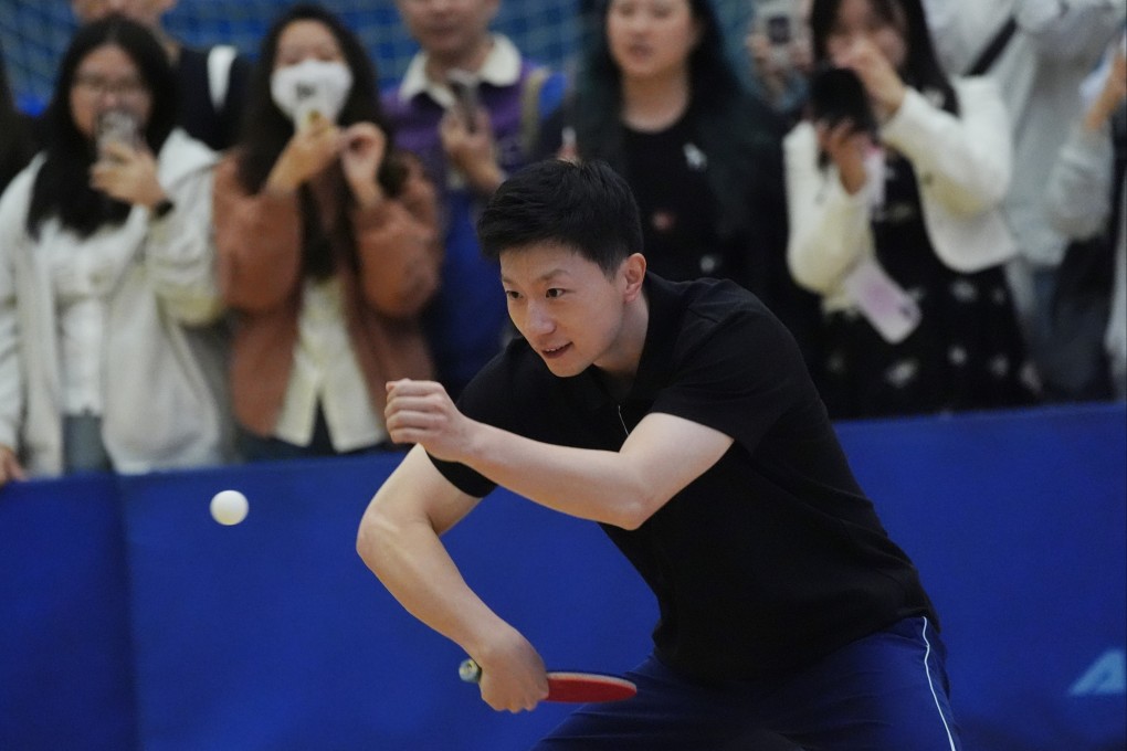 Fans capture the moment as Ma Long plays table tennis at Polytechnic University. Photo: Elson Li