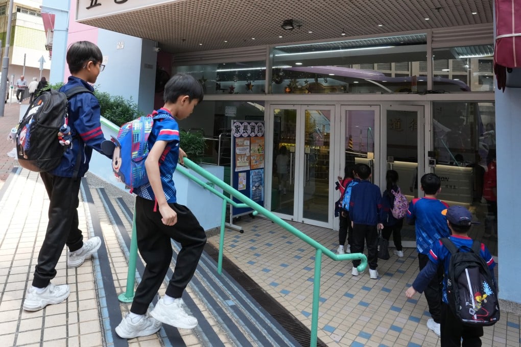 Students walk into the Five Districts Business Welfare Association School in Cheung Sha Wan on March 18. Photo: Jelly Tse