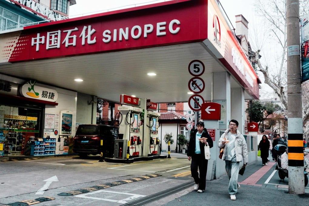 People walk past a petrol station in Shanghai on Thursday. China imported 159.79 million barrels of Russian crude in the first two months of this year. Photo: EPA