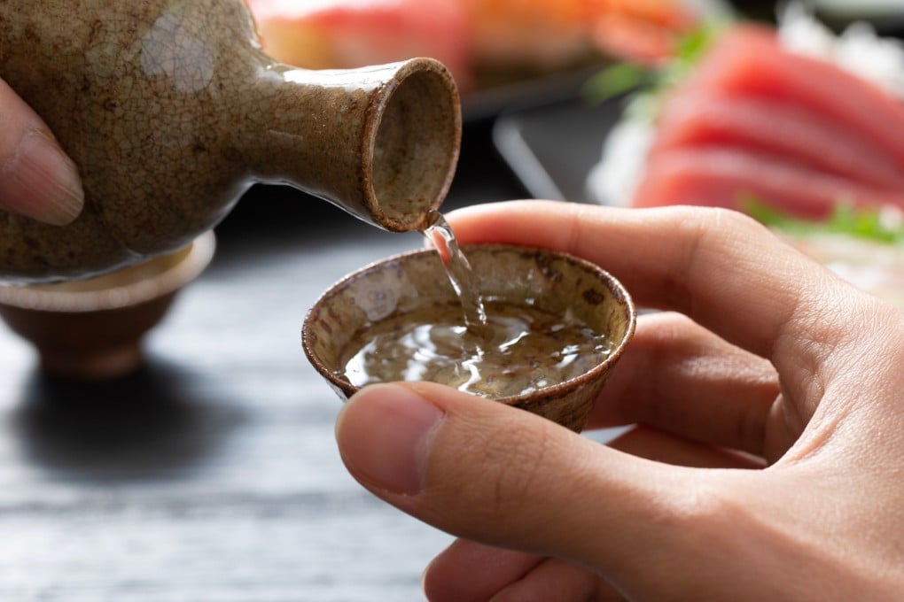 Pouring sake for others and refilling their glasses before they are empty is an act of hospitality and attentiveness in Japan. Photo: Shutterstock