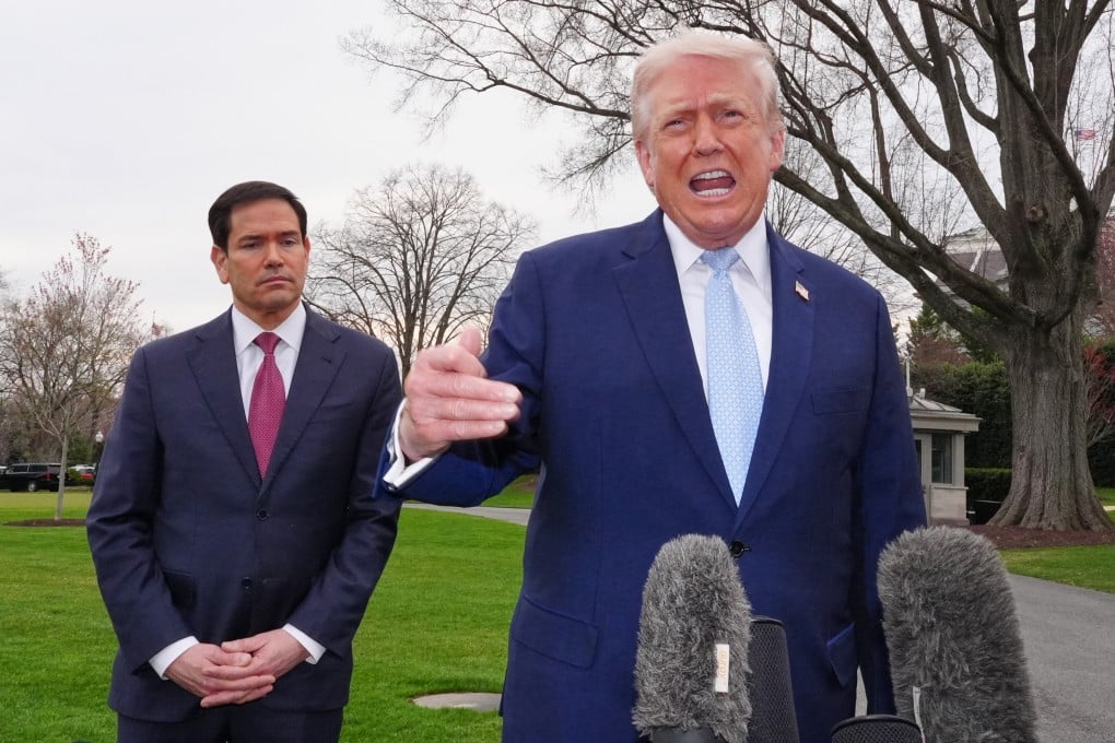 US President Donald Trump speaks with reporters at the White House on Friday, as Secretary of State Marco Rubio listens. Photo: AP