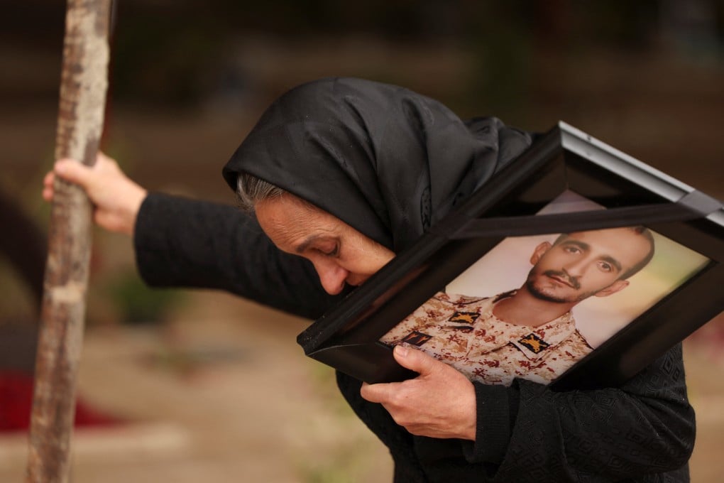 A woman stands near the grave of her son at a cemetery in Tehran on Monday. Her son was killed during recent US-Israeli strikes on Iran. Photo: Reuters