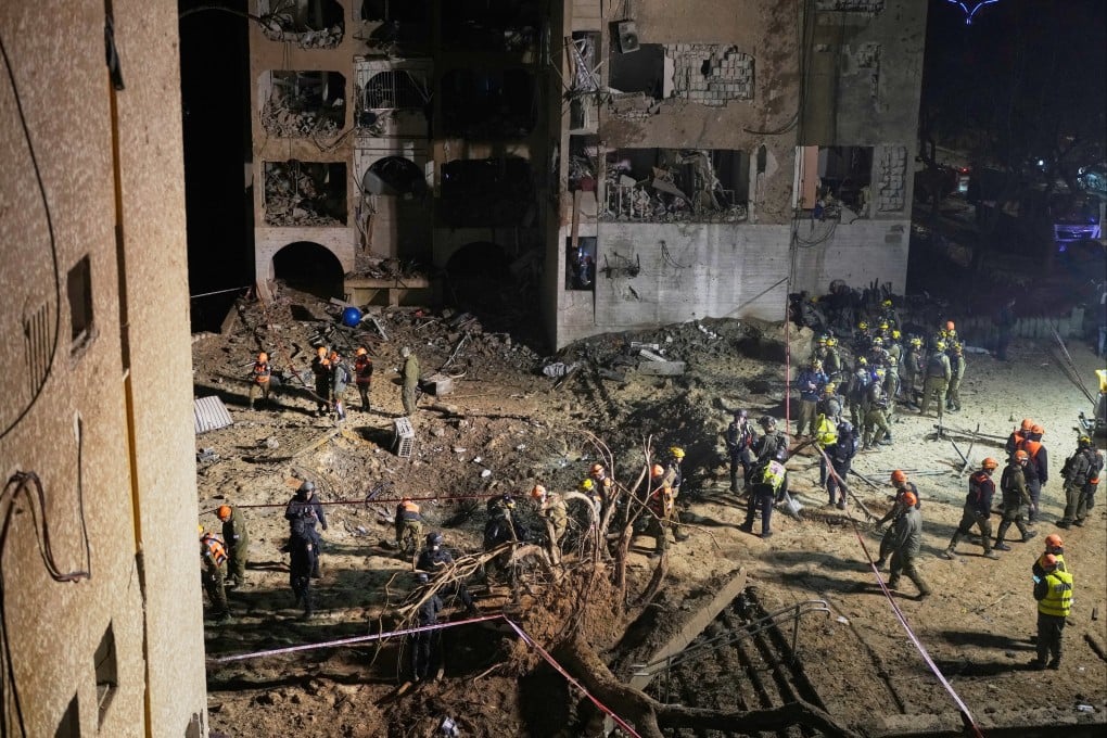 Israeli security forces and rescuers work at the site struck by an Iranian missile in Arad, southern Israel, on Sunday. Photo: AP