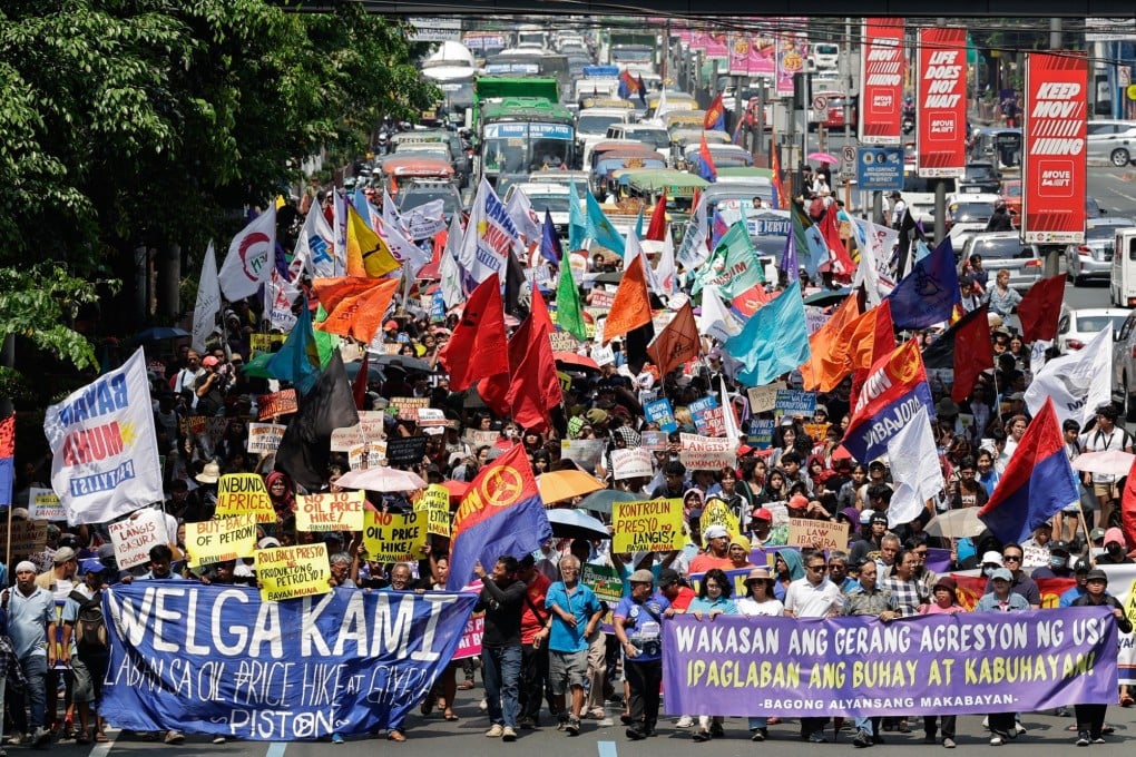 Protesters opposing fuel price hikes walk along a road in Manila, Philippines, on Friday. Photo: EPA-EFE