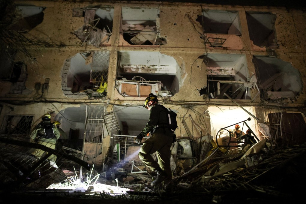 An Israeli soldier inspects the damage after Iranian missiles struck Dimona on Saturday. Photo: Reuters