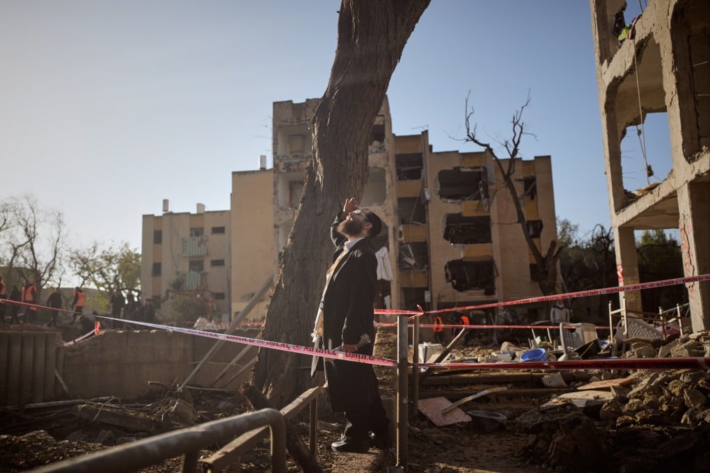 A man looks at residential buildings damaged by an Iranian missile strike in Arad, southern Israel, on Sunday. Photo: AP