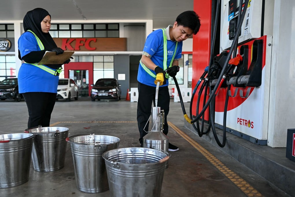 A worker pumps fuel at a petrol station in Sarawak, Malaysia. Photo: AFP