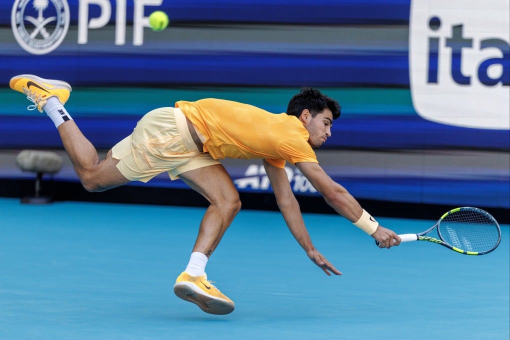 Carlos Alcaraz scrambles to get the ball back during his shock Miami Open defeat by Sebastian Korda. Photo: EPA