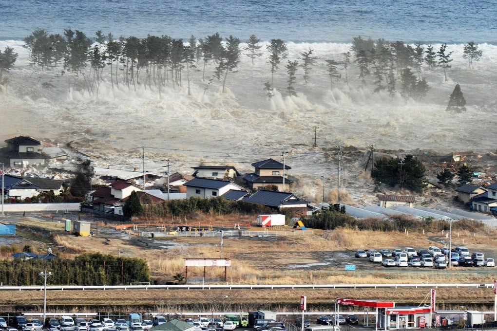 Tsunami waves hit a residential area after a powerful earthquake in Natori, Miyagi prefecture, Japan, in 2012. Photo: AP/Kyodo News