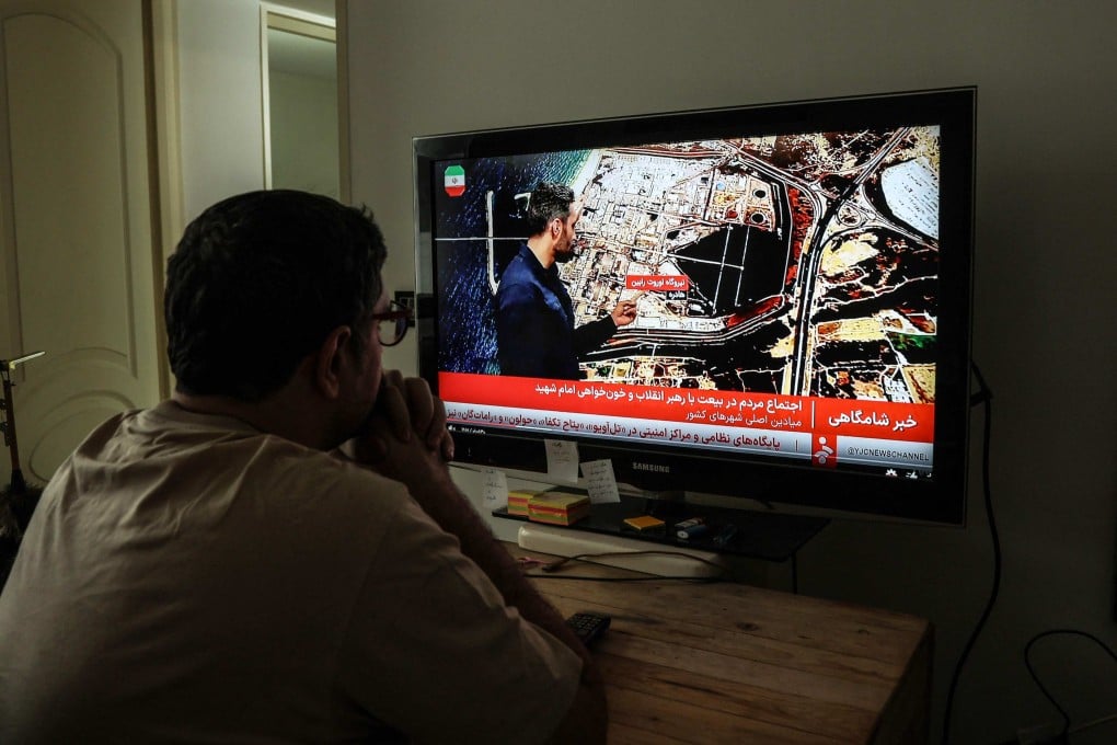 An Iranian man watches the news in Tehran. Photo: AFP