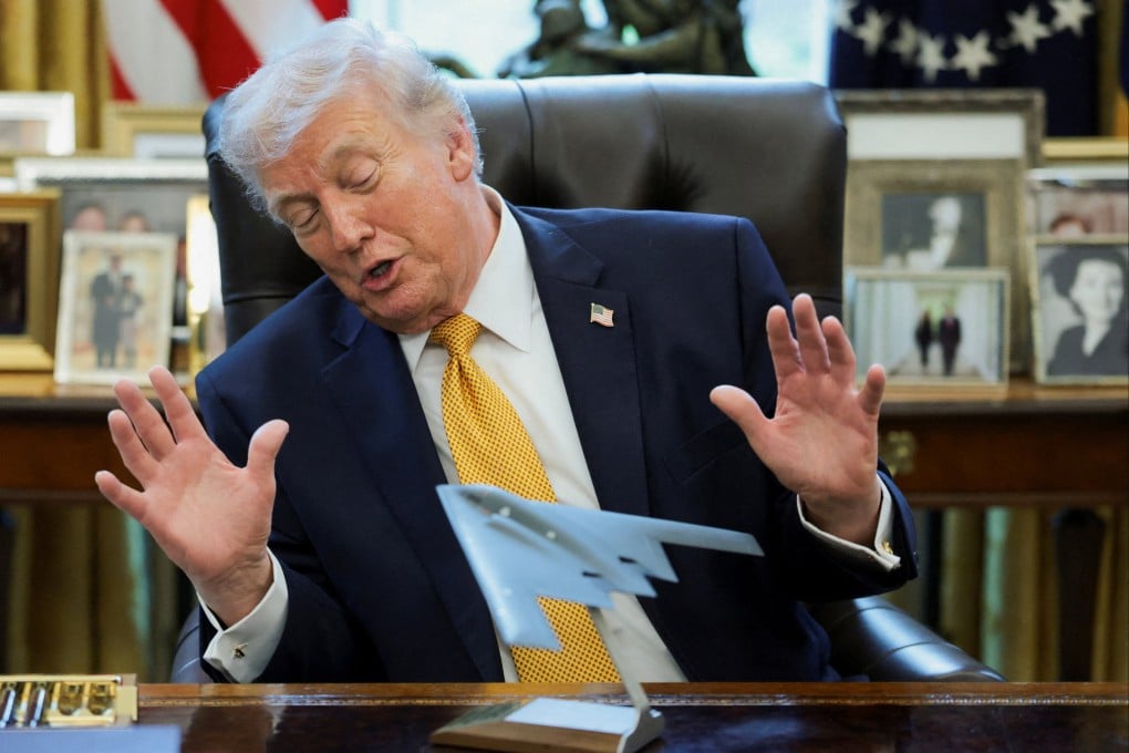 US President Donald Trump looks at a model of a B-2 bomber commemorating ‘Operation Midnight Hammer’ against Iran. Photo: Reuters