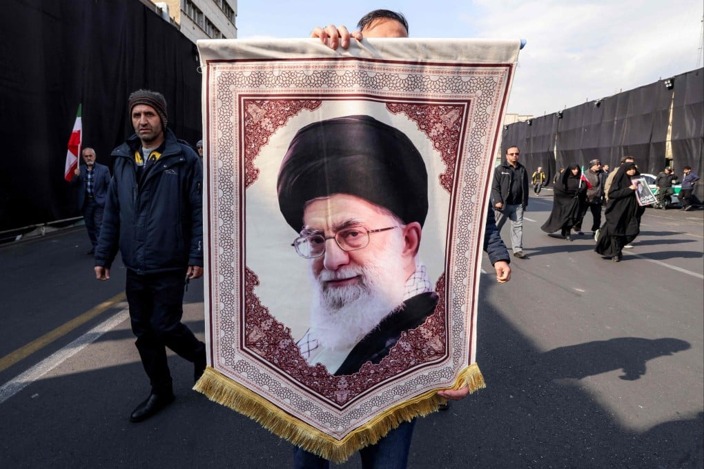 A man in Tehran marches with a banner depicting Iran’s late Supreme Leader Ayatollah Ali Khamenei, who was killed on February 28 in a US-Israeli strike. Photo: AFP