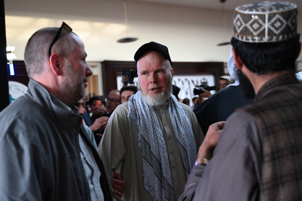 US citizen Dennis Coyle (middle) waits at the airport in Kabul on Tuesday after the Taliban released him. Photo: AFP