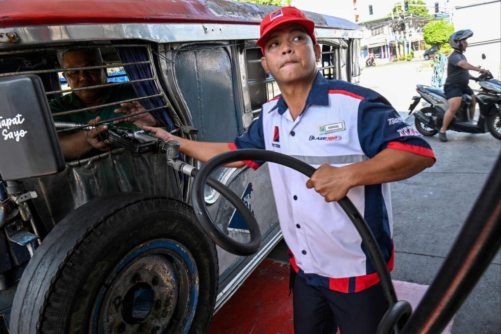A Jeepney driver refuels his vehicle with diesel at a fuel station in Manila on Monday. Photo: AFP