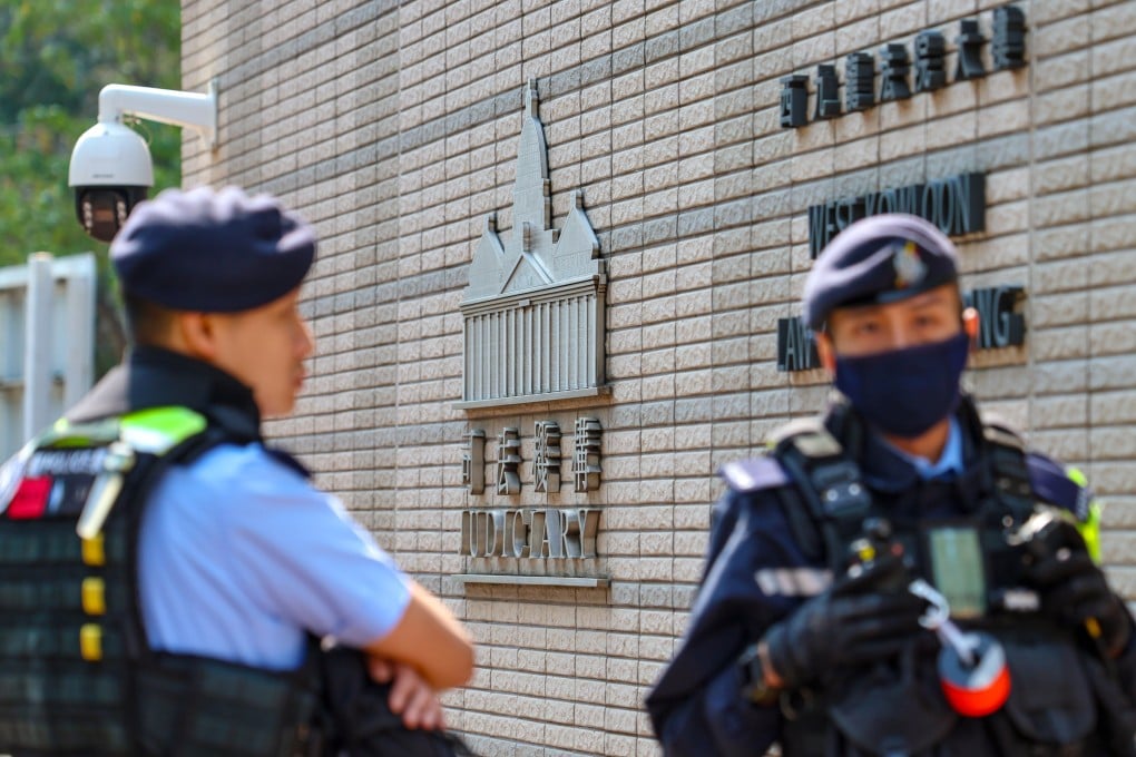 Police officers outside court in West Kowloon on February 23, on the day the Court of Appeal delivered a verdict on a case involving conspiracy to commit subversion. Photo: Dickson Lee