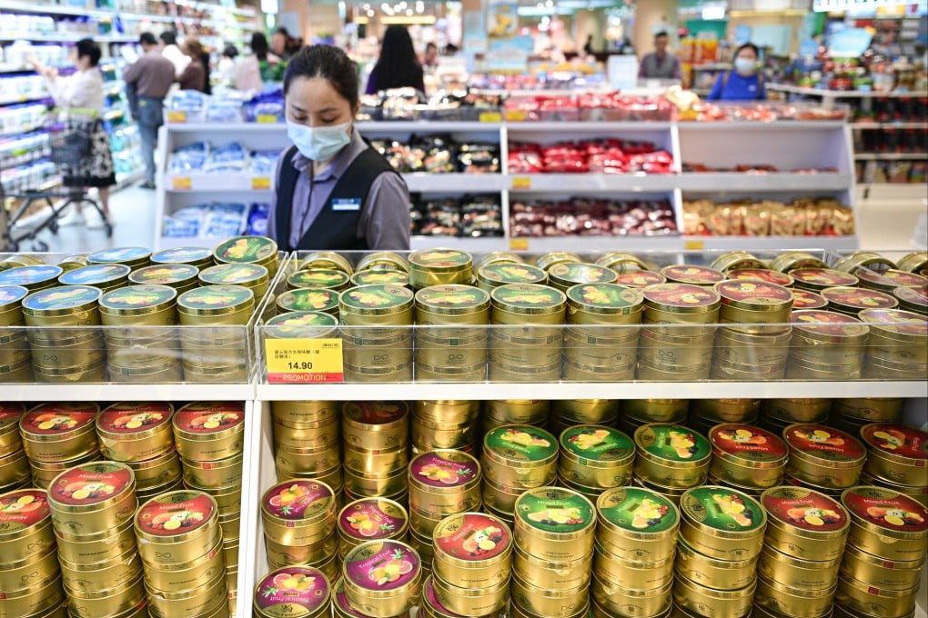 A worker keeps an eye on the shelves of a duty-free grocery shop in Hainan province. Photo: Xinhua