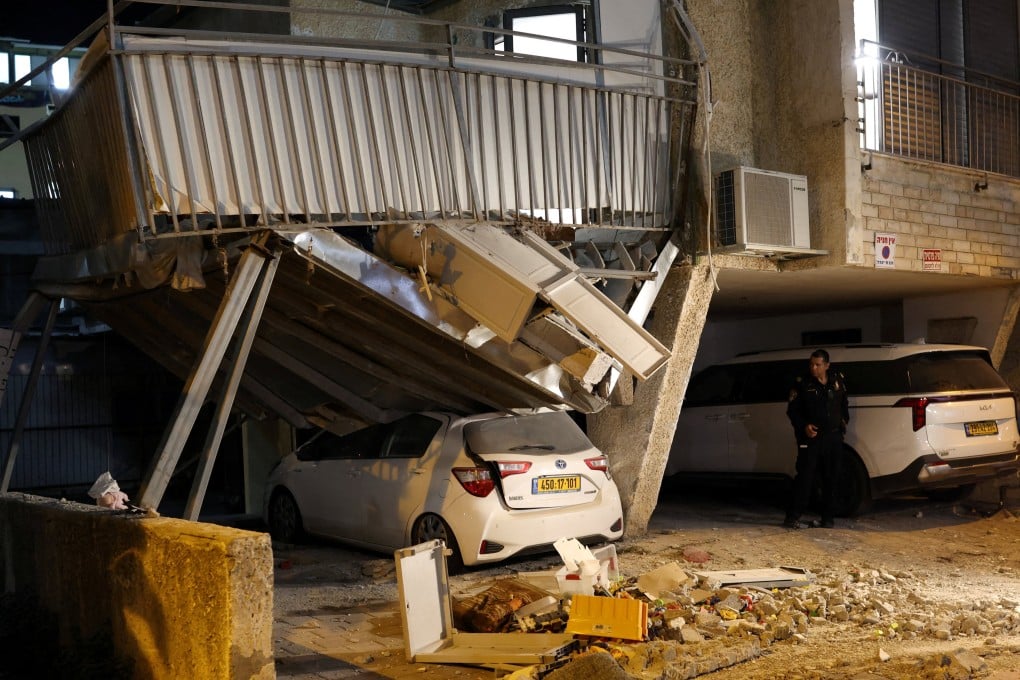 A first responder looks at damage following Iranian missile barrages in central Israel. Photo: Reuters