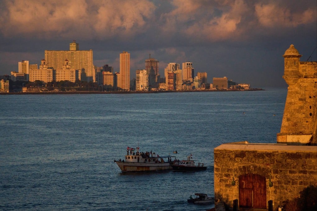 Activists wave Cuban and Palestinian flags from the vessel Maguro in Havana Bay, Cuba. Photo: AP