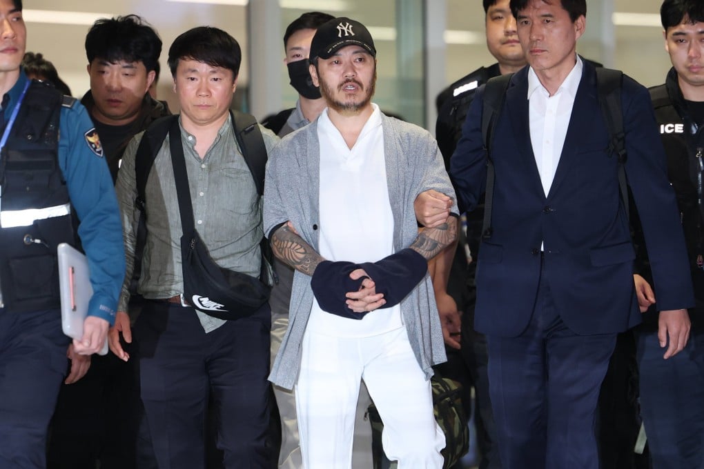 Park Wang-yeol (centre), a South Korean national detained in the Philippines, arrives at Incheon International Airport in South Korea on Wednesday. Photo: Yonhap/EPA