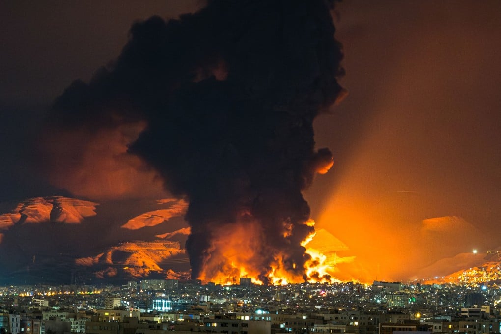 Smoke and flames rise above Tehran after air strikes on an oil depot on March 7. The economic disruptions caused by the US-Israel war on Iran have pushed up costs for Chinese manufacturers, causing some factories to halt production. Photo: TNS