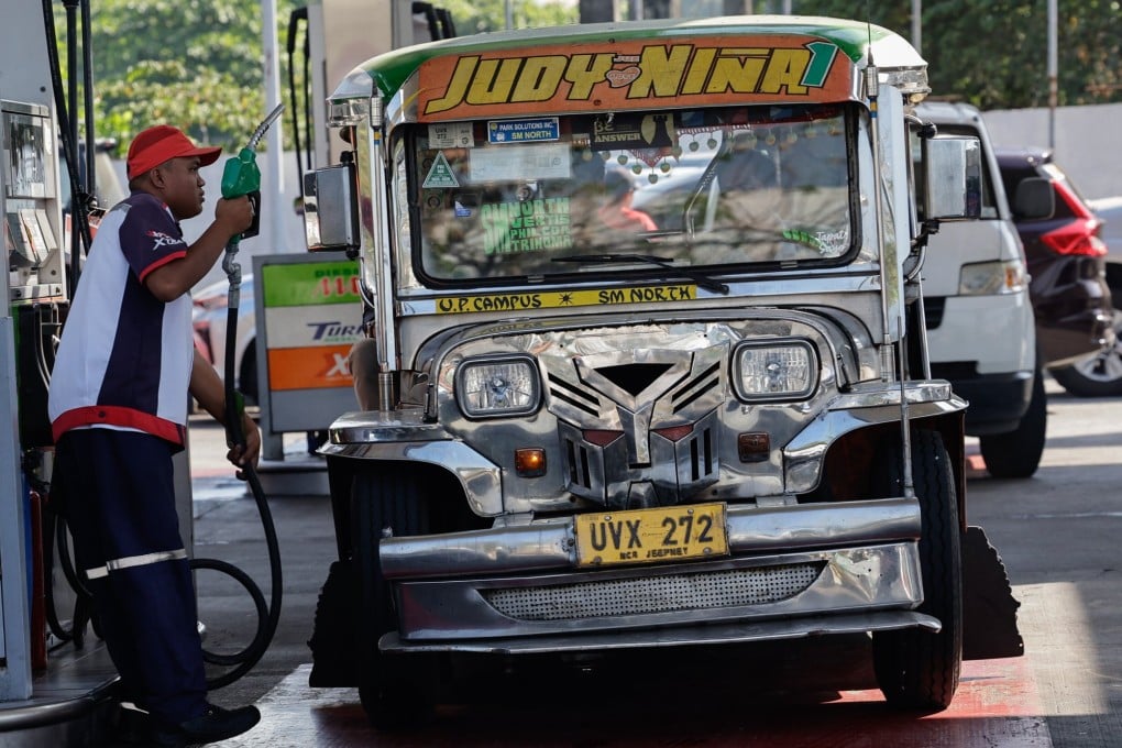 A fuel station worker prepares to refuel a jeepney, or local minibus, in Quezon City, the Philippines, on Wednesday. Photo: EPA
