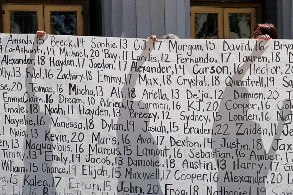 Parents who say they have lost their children due to social media hold up a banner with names outside the court. Photo: Reuters