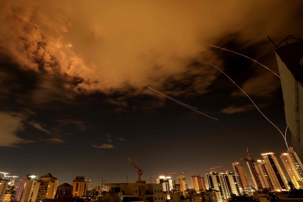 Rocket trails are seen in the sky above the Israeli coastal city of Netanya amid a fresh barrage of Iranian missile attacks on Wednesday. Photo: AFP