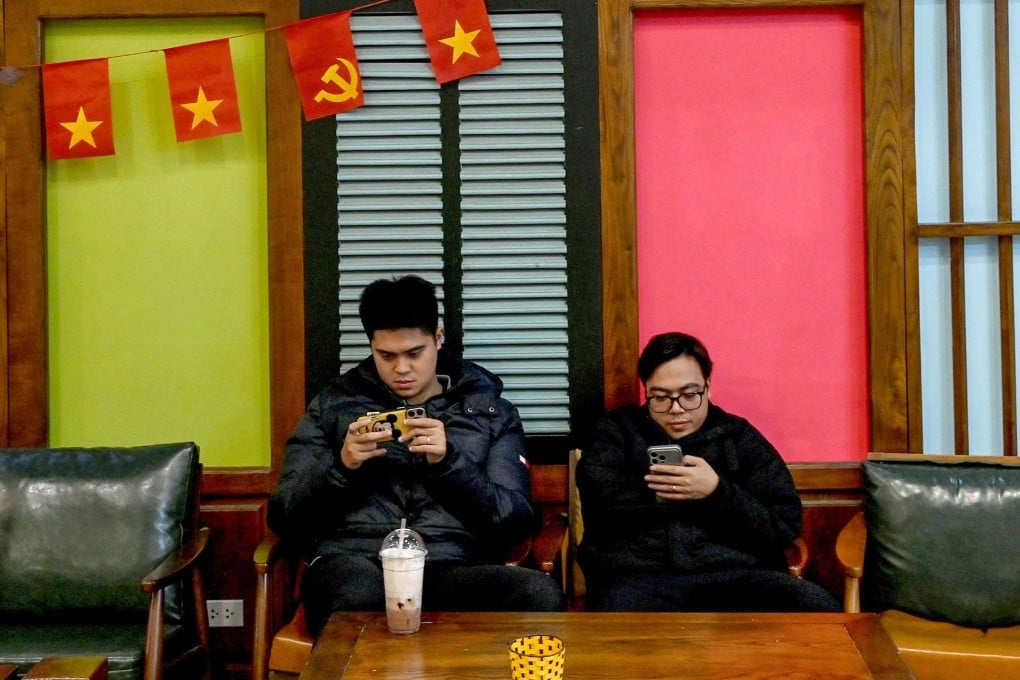 Men use their phones at a cafe in Hanoi, Vietnam, in January. Photo: AFP