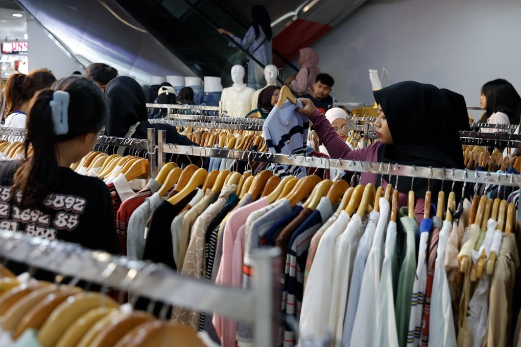 People shop for clothes at a market in Jakarta, Indonesia, on March 16. Photo: EPA