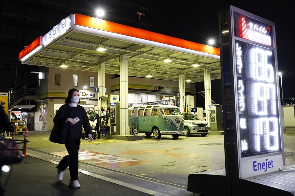 A pedestrian walks past a petrol station in Tokyo, Japan, on March 18. Photo: EPA