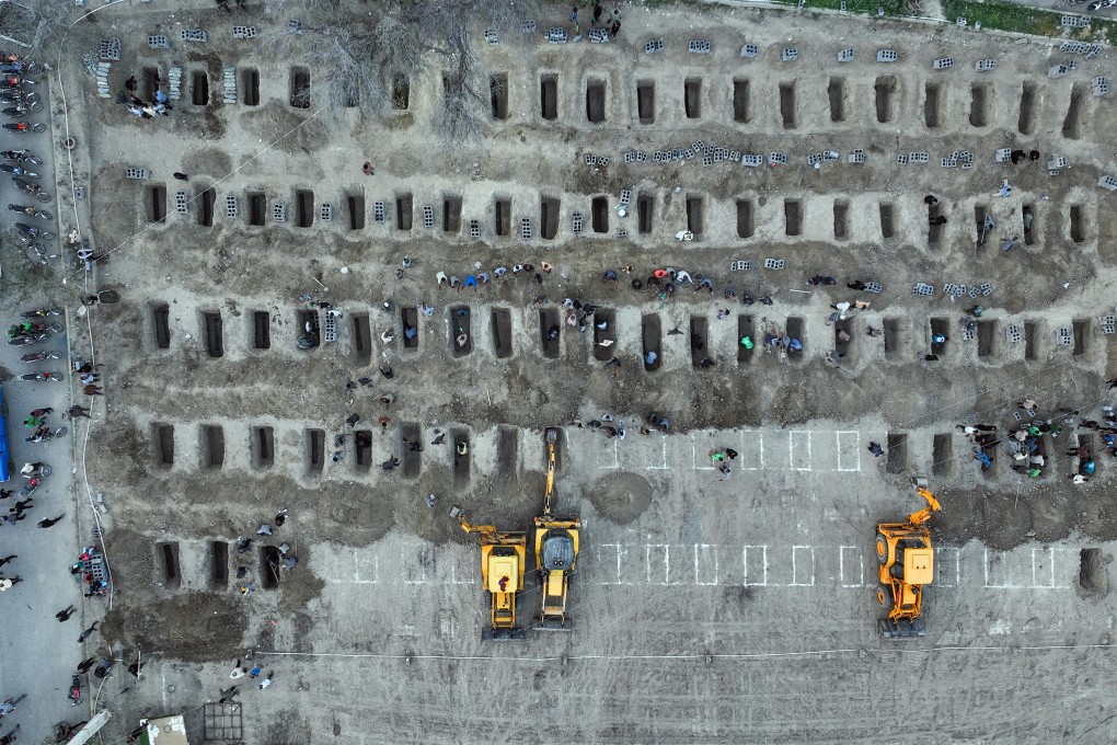 Mourners dig graves during the funeral for children killed in a US-Israeli strike on a school in Minab, Iran, on March 3. Photo: Iranian Press Centre/AFP/Getty Images/TNS