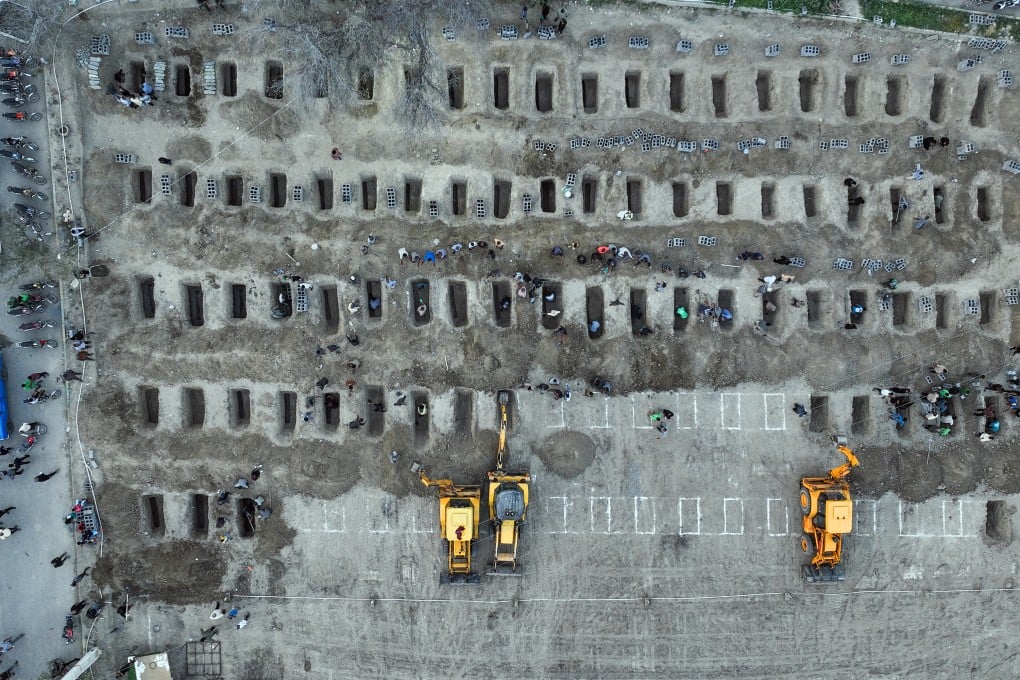 Mourners dig graves during the funeral for children killed in a US-Israeli strike on a school in Minab, Iran, on March 3. Photo: Iranian Press Centre/AFP/Getty Images/TNS
