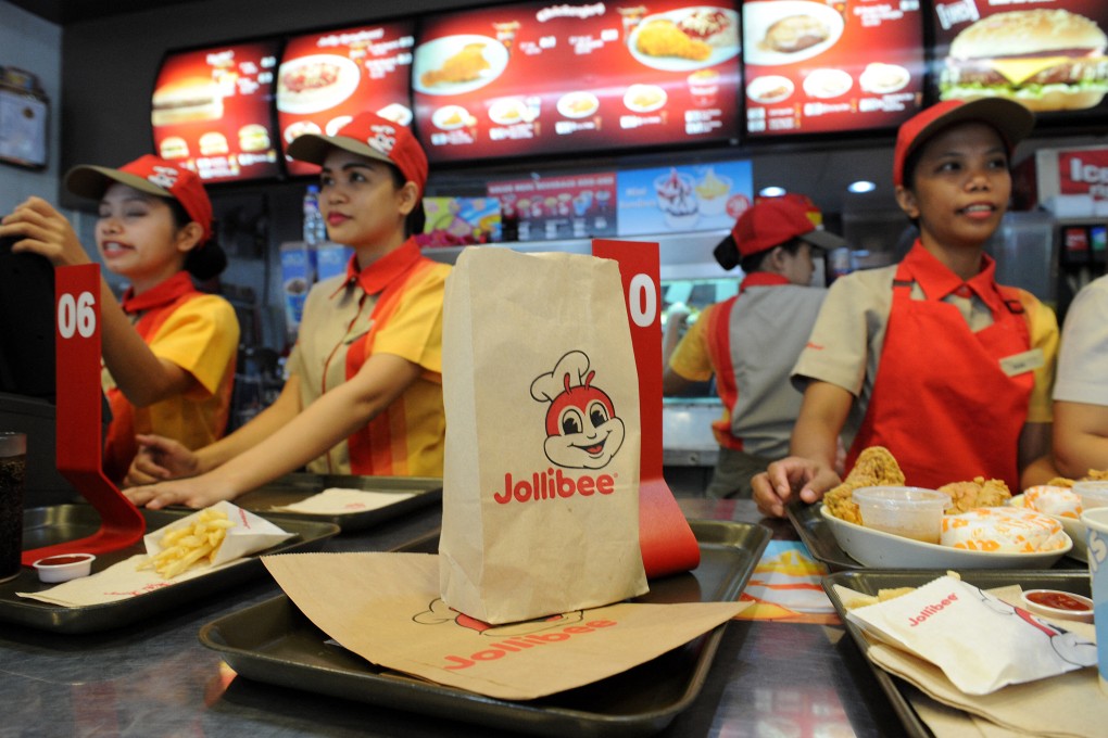 Jollibee employees attend to customers at an outlet in Manila in 2015. Photo: AFP