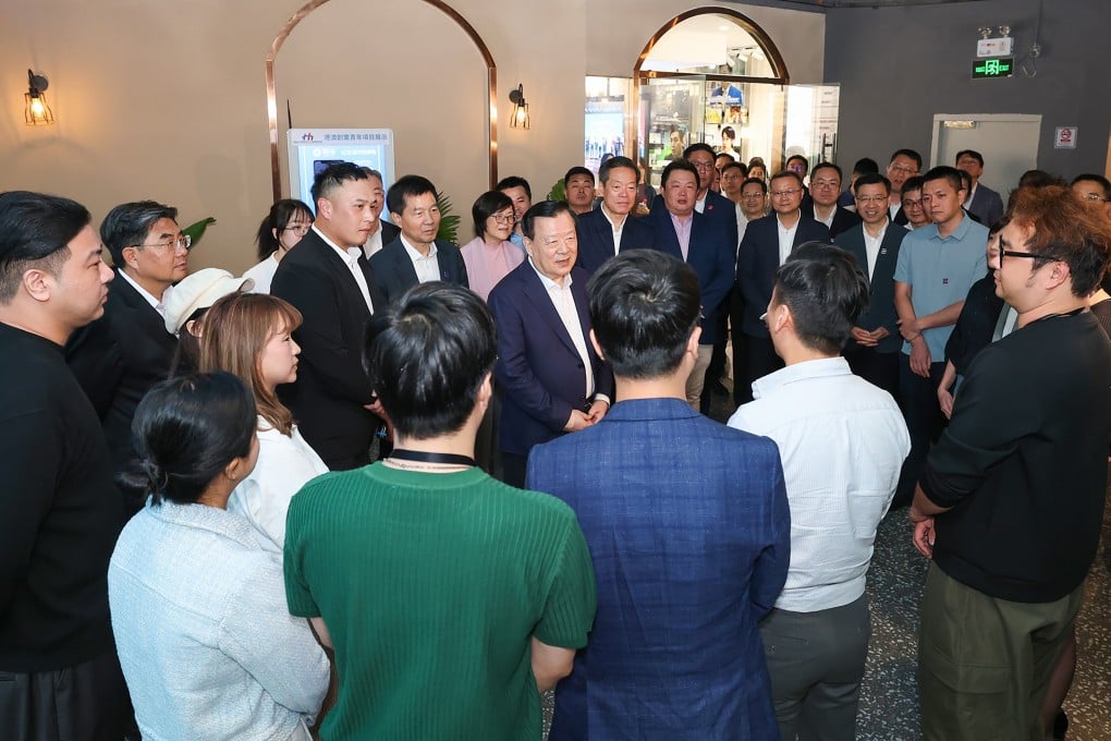 Xia Baolong (centre) visits the Guangzhou Tianhe Hong Kong and Macao Youth Association during his trip. Photo: Handout