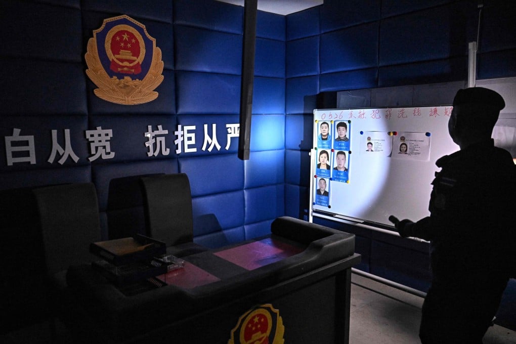 A Thai soldier shines a torch into a room disguised as a Chinese police station inside an abandoned scam centre on the Thai-Cambodian border on March 12. Photo: AFP