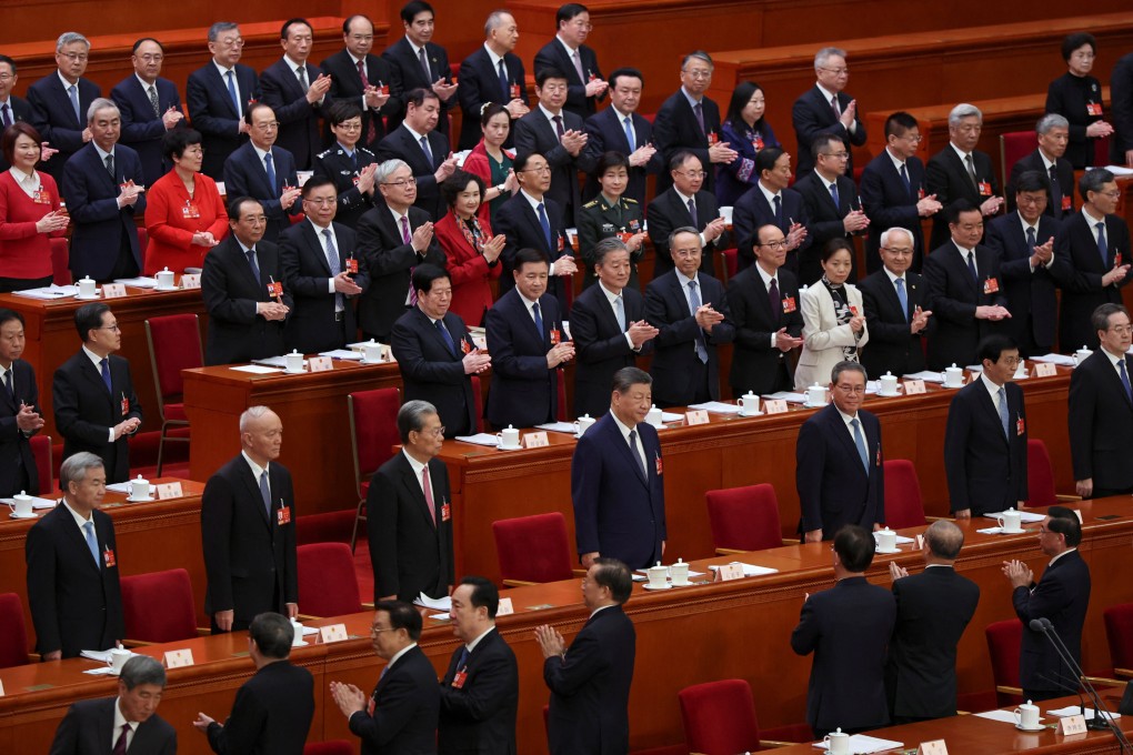 Delegates applaud as Chinese President Xi Jinping and other members of the Politburo arrive for a meeting of the National People’s Congress at the Great Hall of the People in Beijing on March 9. Photo: Reuters