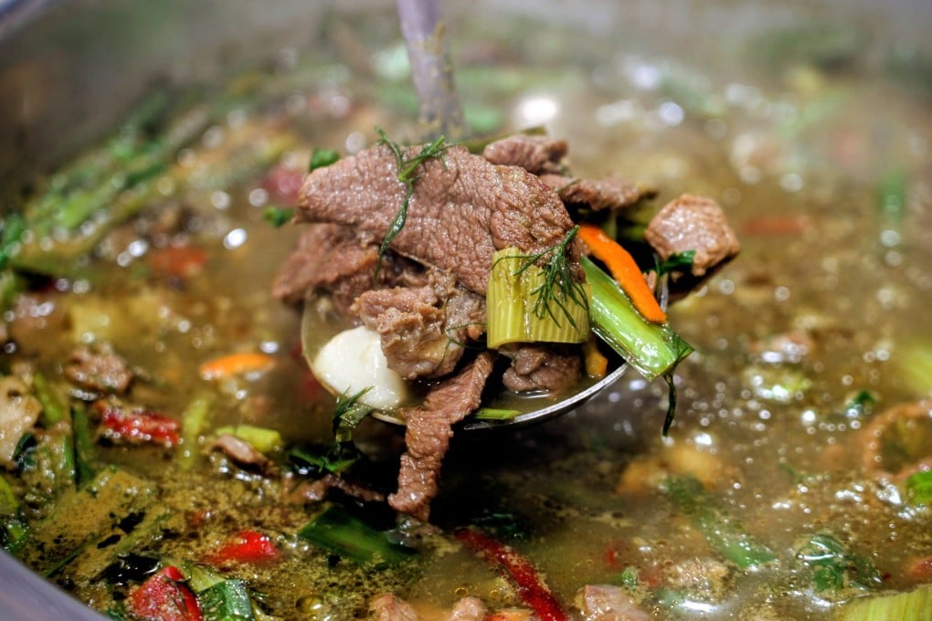 A ladle of Guizhou’s famous cow dung hotpot in the Rong Jiang Niu Bie Huo Wo Dian restaurant in Zunyi city. The dish’s ingredients include bile and undigested grass from a cow’s stomach and intestines. Photo: Llewellyn Cheung