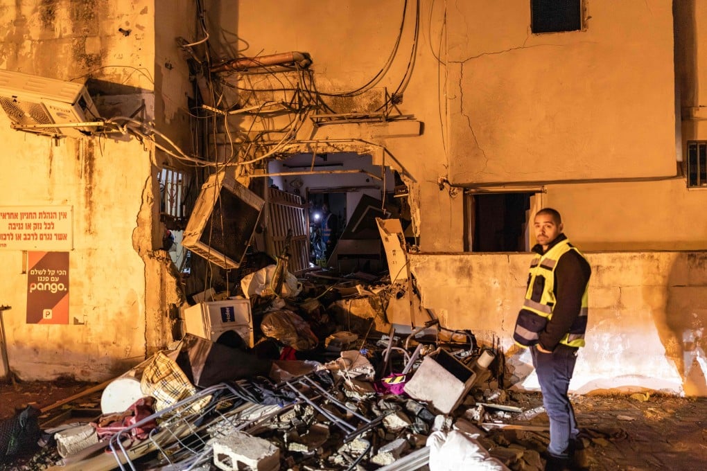 People search for their belongings in a building damaged by a strike in Tel Aviv on Saturday. Israeli army reported missiles fired by Iran at Israel on Friday evening. Photo: AFP
