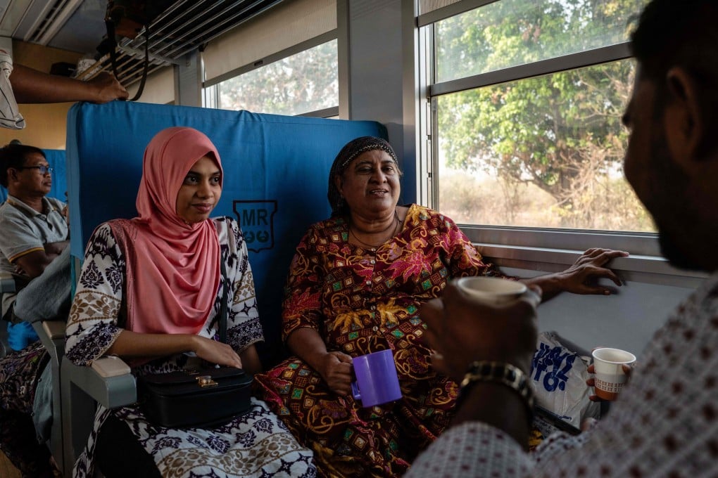 Passengers drink tea as they travel on a train from Yangon to Naypyidaw on Thursday. Photo: AFP