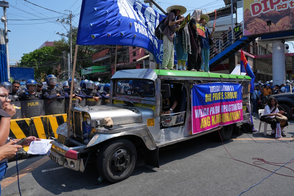 Protesters use a jeepney as a stage during a rally by transport workers and activists protesting the rise in oil prices on Friday, near the Malacanang presidential palace in Manila, Philippines. Photo: AP