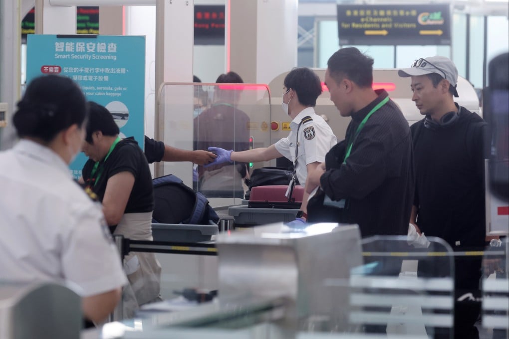 Airport Authority security check officers scan passenger baggage at Hong Kong International Airport in Chek Lap Kok on March 29. Photo: Edmond So