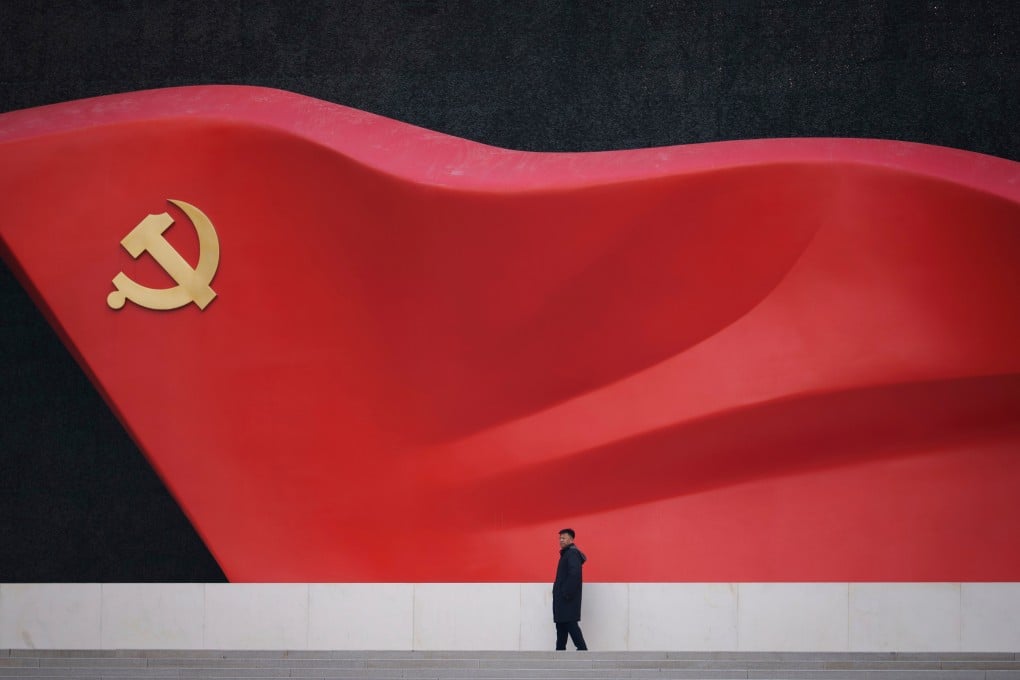 A man walks past a large sculpture of the Communist Party flag at the Chinese Communist Party History Exhibition in Beijing, on March 1. Photo: AP
