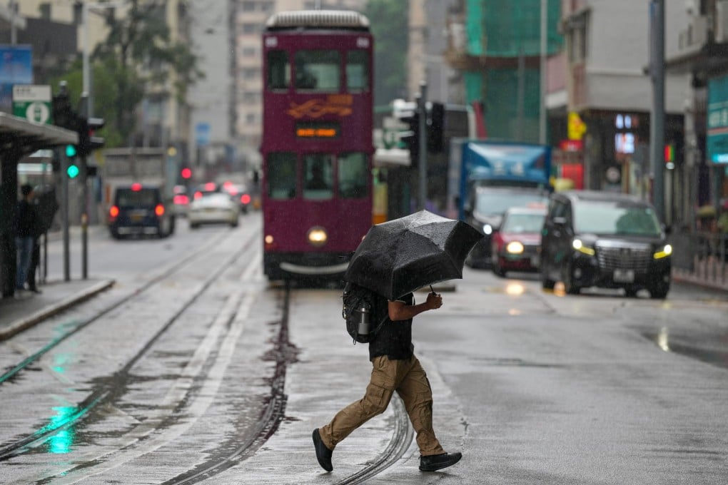 A resident crosses the road in San Wan on Monday morning. Photo: Karma Lo