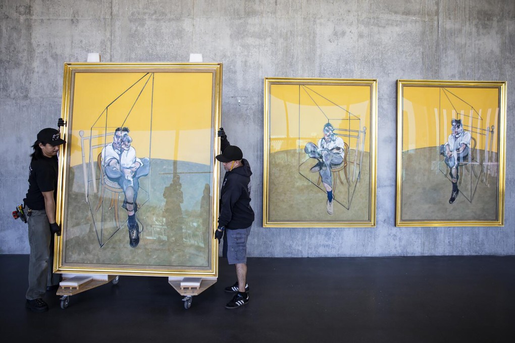 Workers install Francis Bacon’s 1969 triptych Three Studies of Lucian Freud in the Los Angeles County Museum of Art’s new David Geffen Galleries on March 11, 2026. Photo: TNS