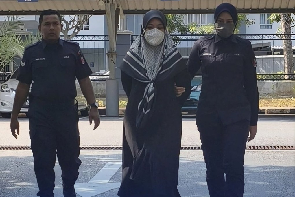 Khairunnisa Ahmad Damamhuri being escorted by police officers. Photo: The Star